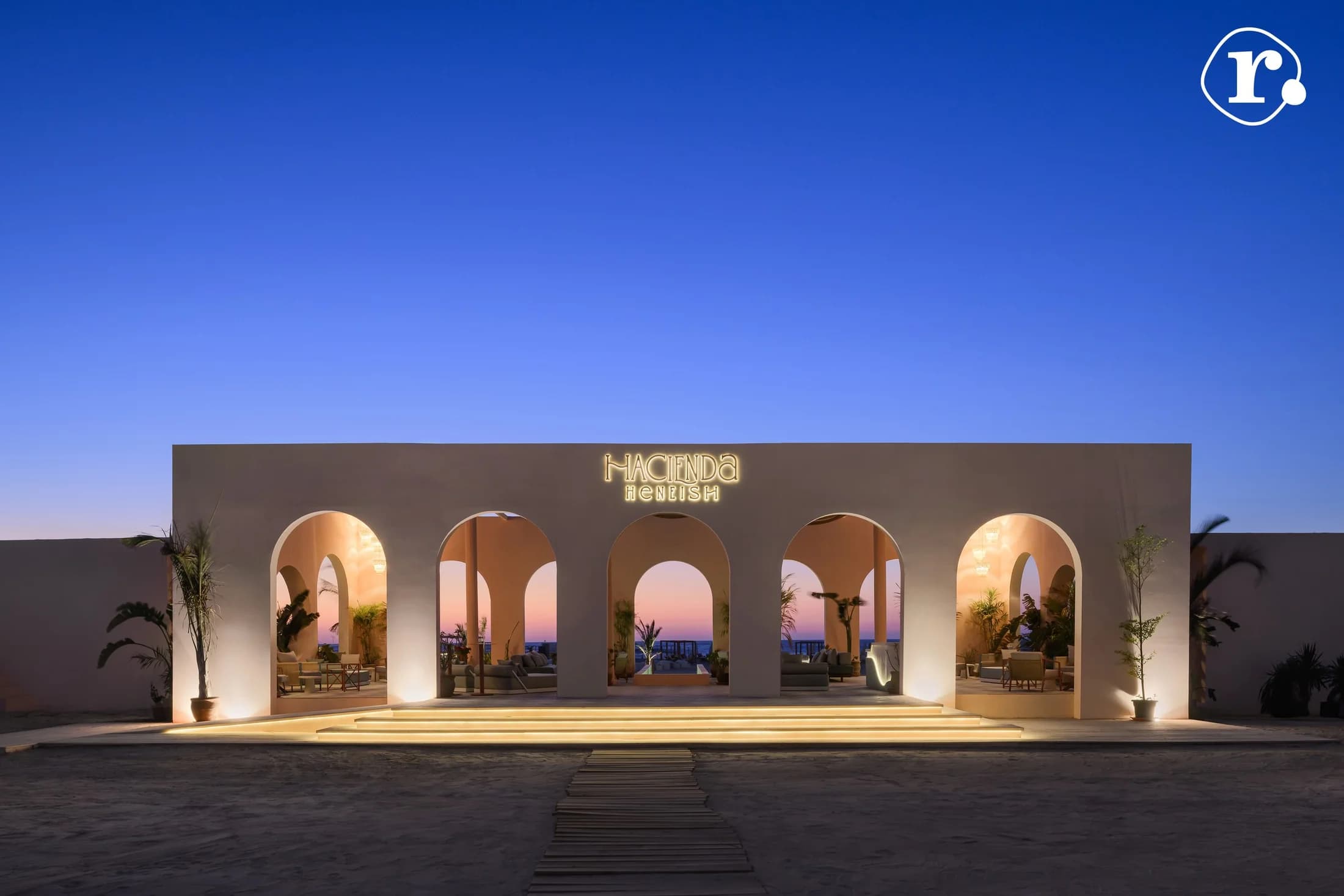 Hacienda Heneish entrance with illuminated arches at dusk