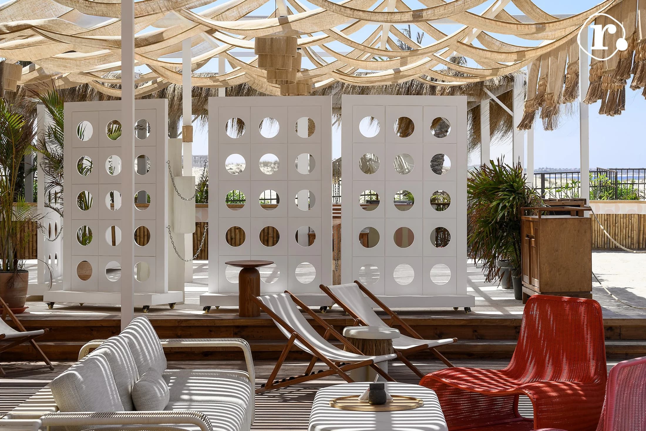 Shaded lounge seating and sculptural screens at Kiki's Chicha