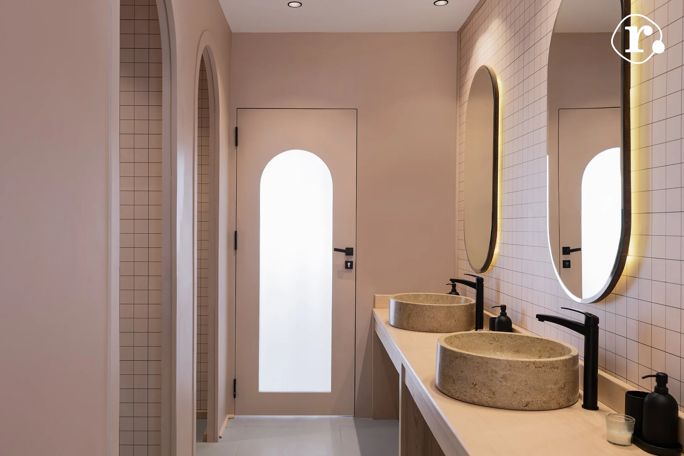 Stone basins and arched mirrors in the interior washroom