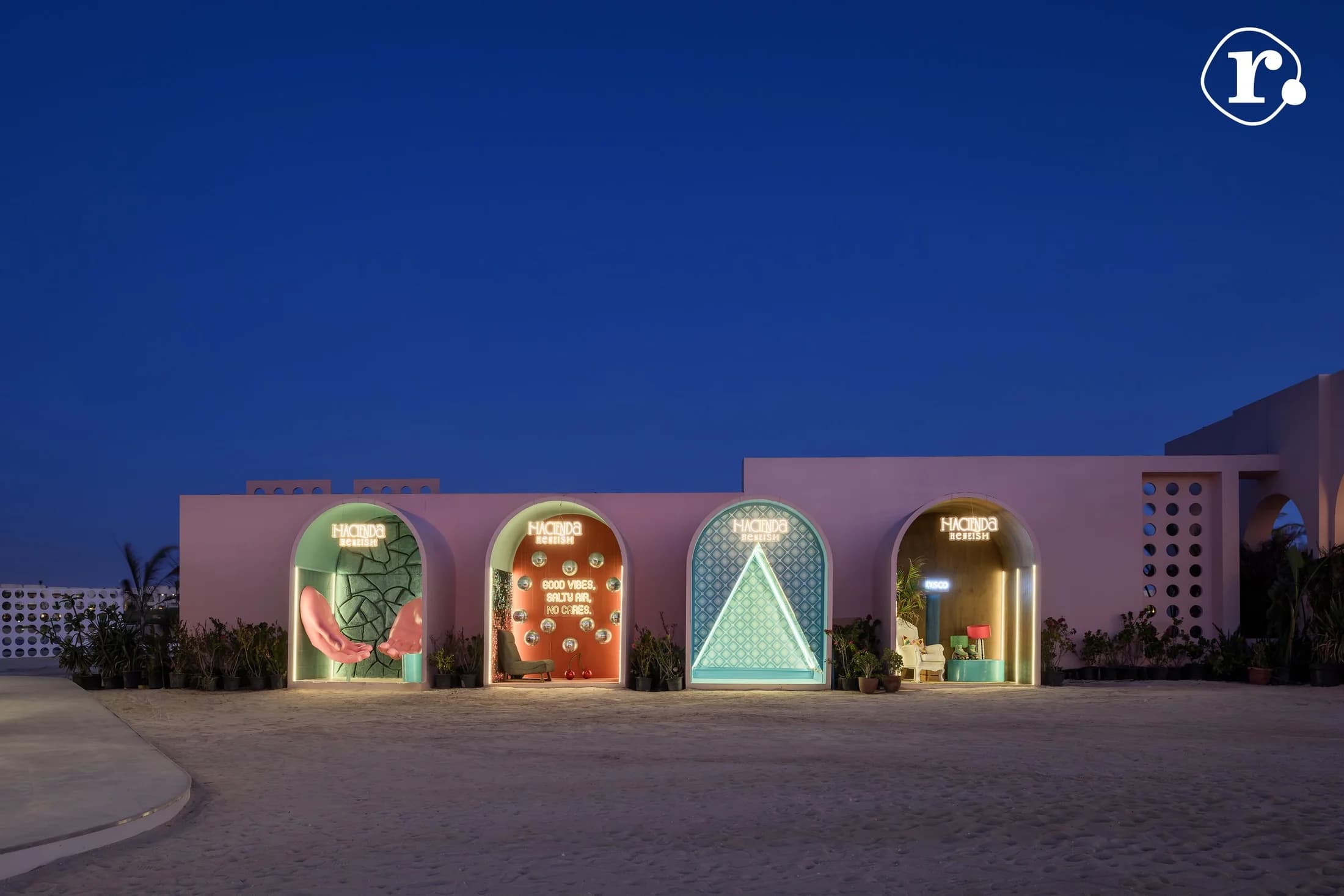 Colourful illuminated arches along the Chicha Club facade at night
