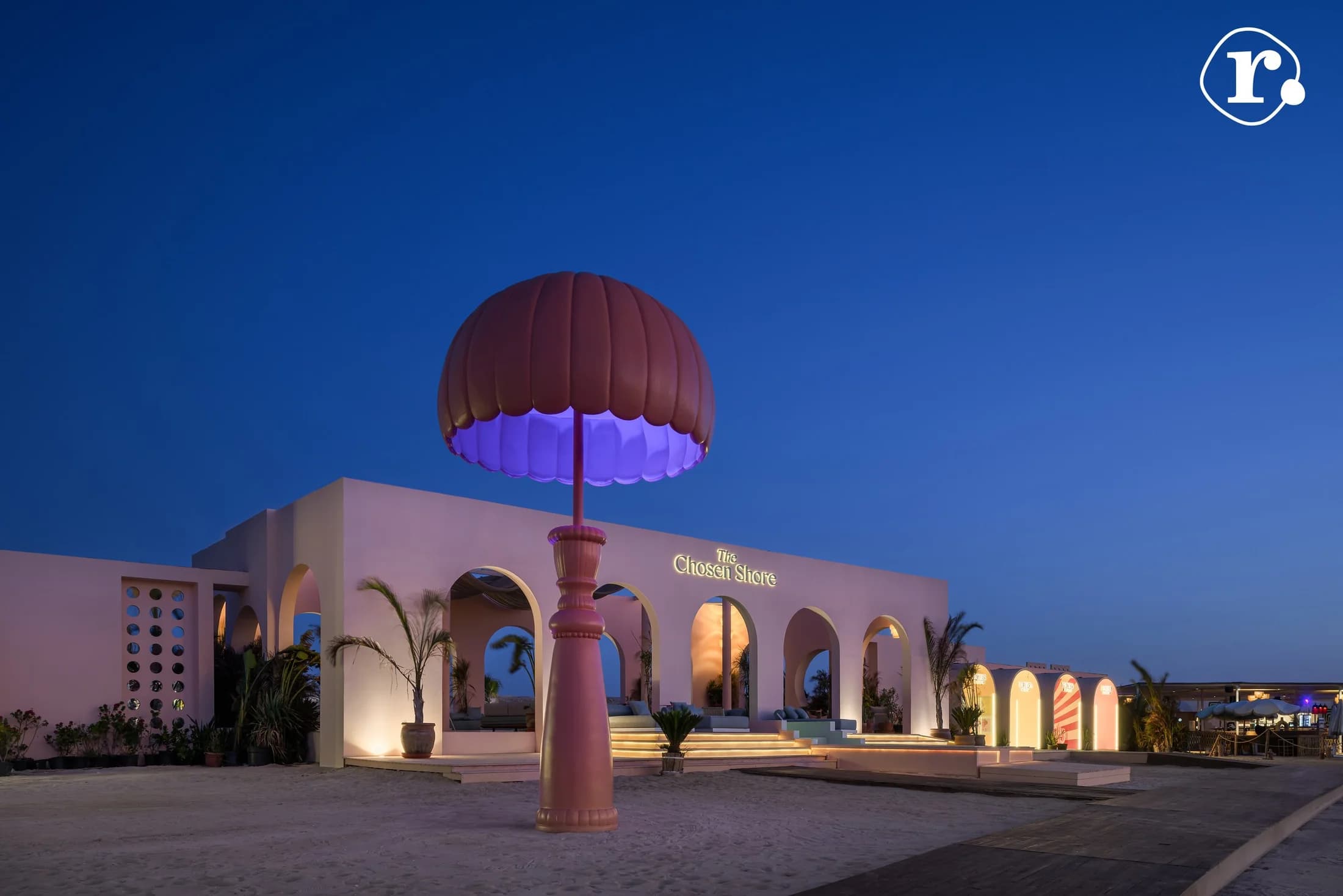 Chicha Club and an oversized illuminated parasol at dusk