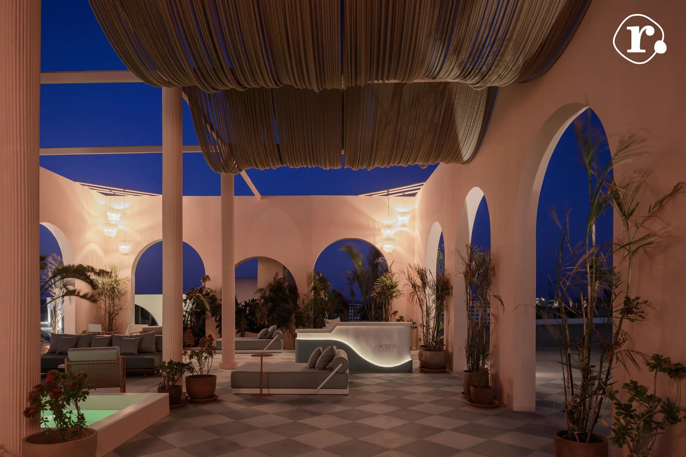 Evening lounge seating beneath drapery and illuminated arches